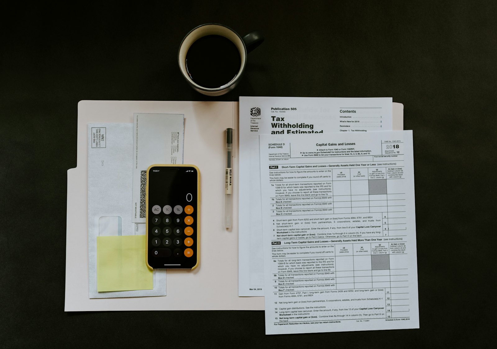 Calculator on an office desk with paperwork